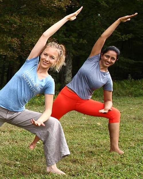 Leigh Bertelsen and another teacher in warrior pose at the Himalayan Institute in autumn